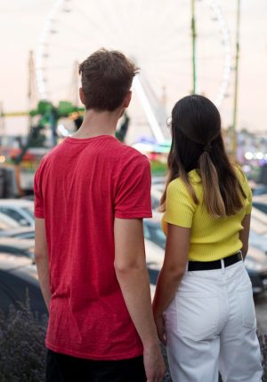 back-view-teenagers-looking-amusement-park